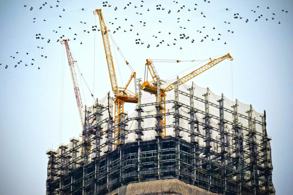 On-site installation of a high-performance building envelope showing the installation of a multi-layer HDPE breathable membrane.